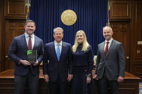 FIA team members Jamie Ulmer (L) and Chad Lincoln (R) are receiving the Forestry for Wildlife Partner recognition from Georgia Governor Brian Kemp and First Lady Marty Kemp.